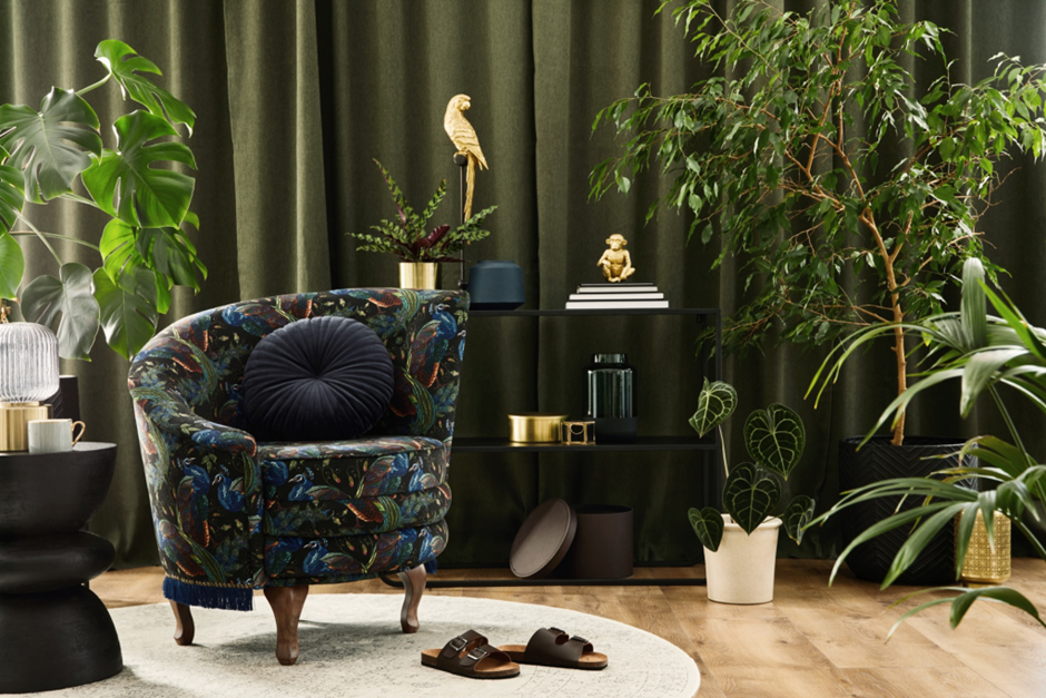 A chair upholstered in a dark floral pattern fabric