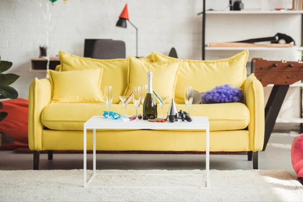 A stylish, bright yellow sofa in a modern living room