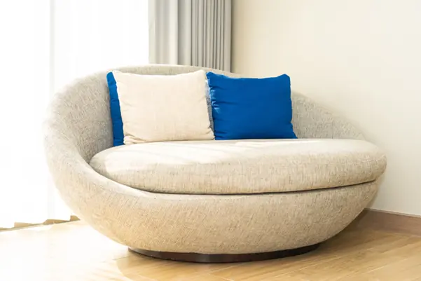 A modern, comfortable-looking round sofa showcasing the high-quality result of reupholstery