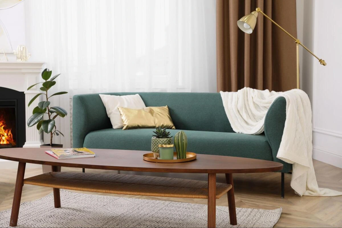 Teal fabric sofa with wooden frame in a bright living room, illustrating sofa frame and material compatibility